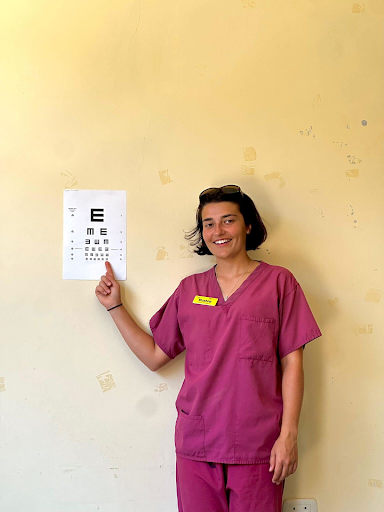Volunteer intern, Katie, assisting in eye testing of the local children
