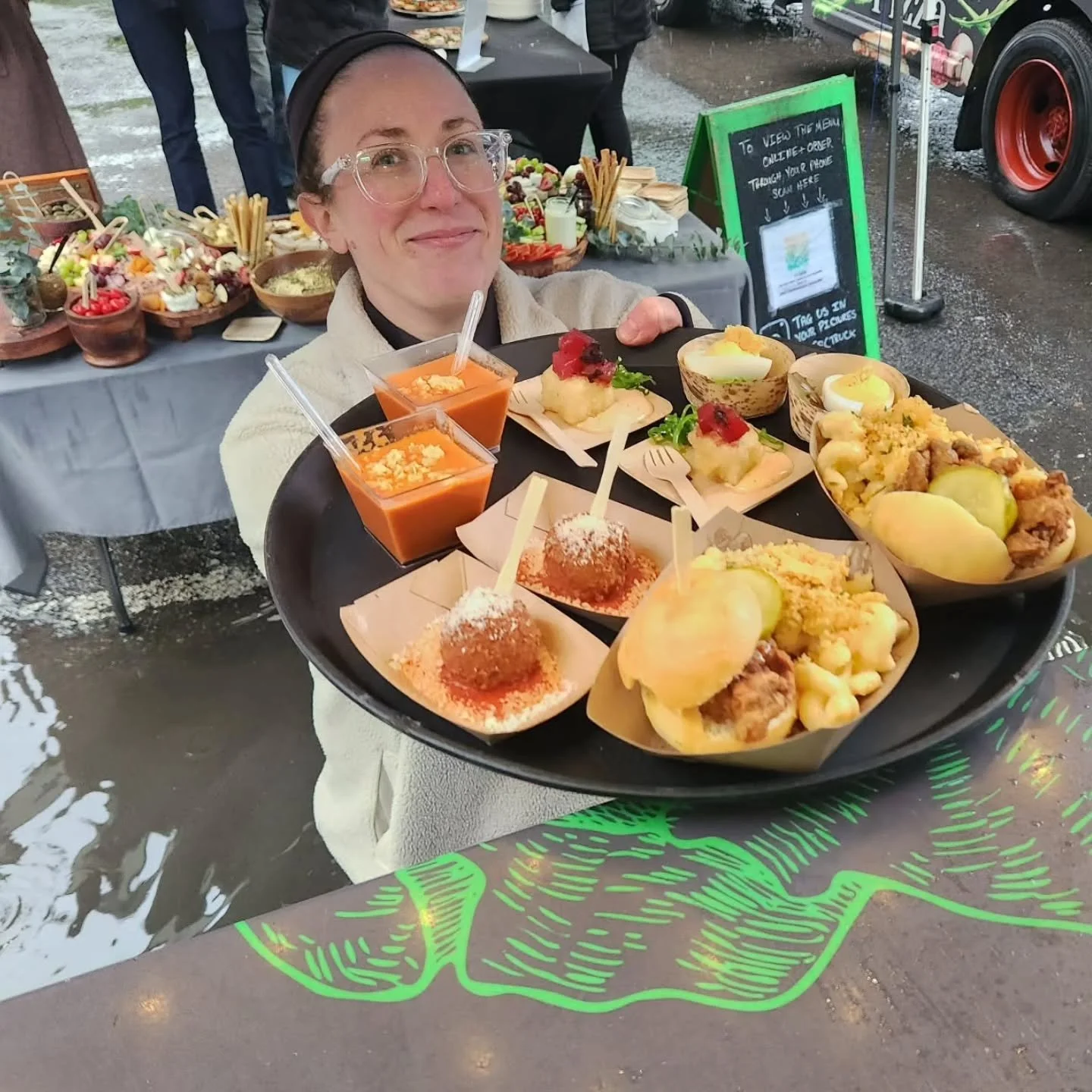 Why yes, that is me standing ankle deep in a puddle of very cold water.

Yesterday's rain got us a bit. 
We showed up to the showcase and had to reposition the truck to accommodate the other trucks not fitting. 
Then the rain came and didn't  quite s