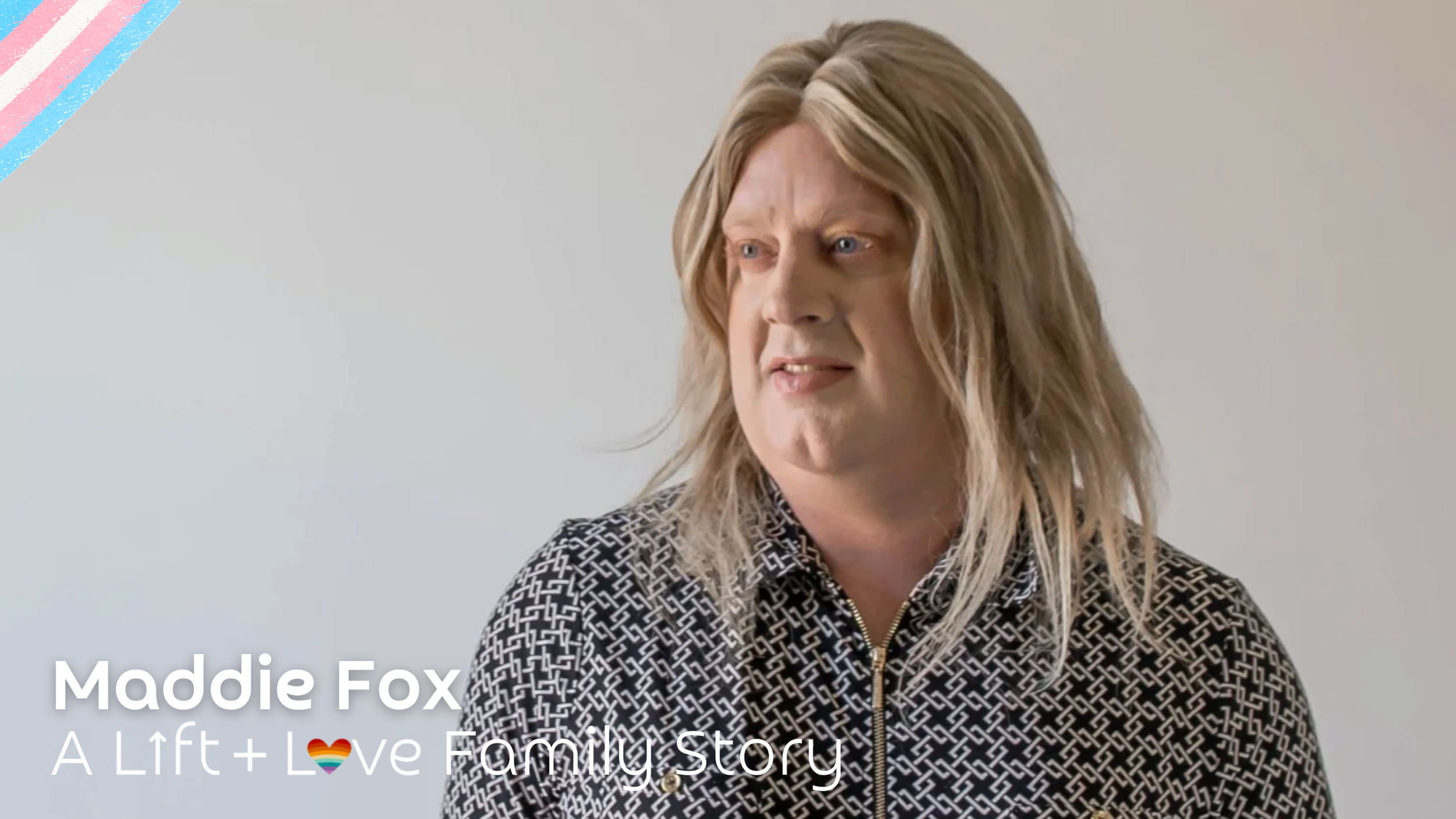 Maddie Fox with shoulder-length blonde hair, wearing a black and white patterned zip-up top, looking to her left against a plain light-colored background.