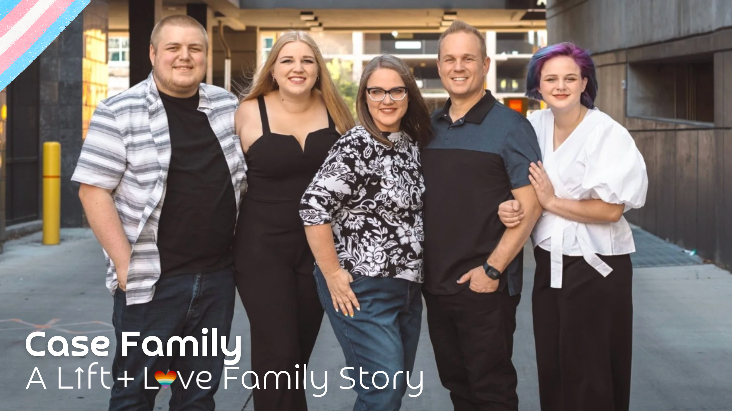 A diverse family group of five people standing close together outdoors, smiling, with a cityscape background. The group includes two men and three women, some with colorful hair, dressed casually. Overlay text reads "Case Family - A Lift + Love Family Story."
