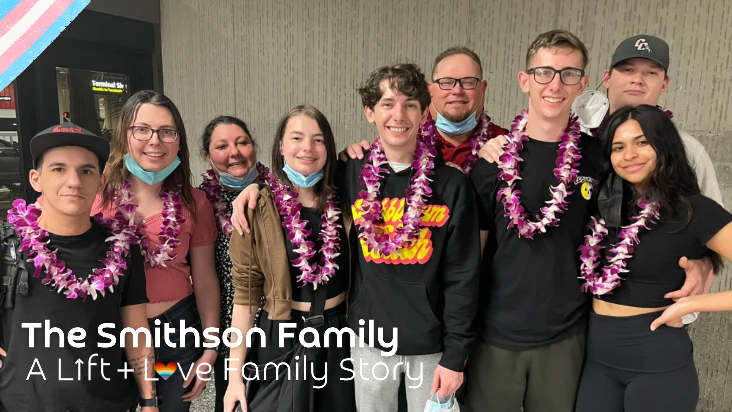 A diverse group of ten people, including young adults and two older adults, posing together at an airport terminal wearing purple lei necklaces, some with face masks around their necks.