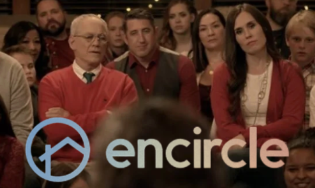 Audience of people attending a presentation or meeting, with a logo and the word 'encircle' in the foreground.
