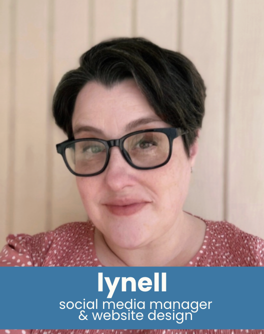 A woman with short dark hair, glasses