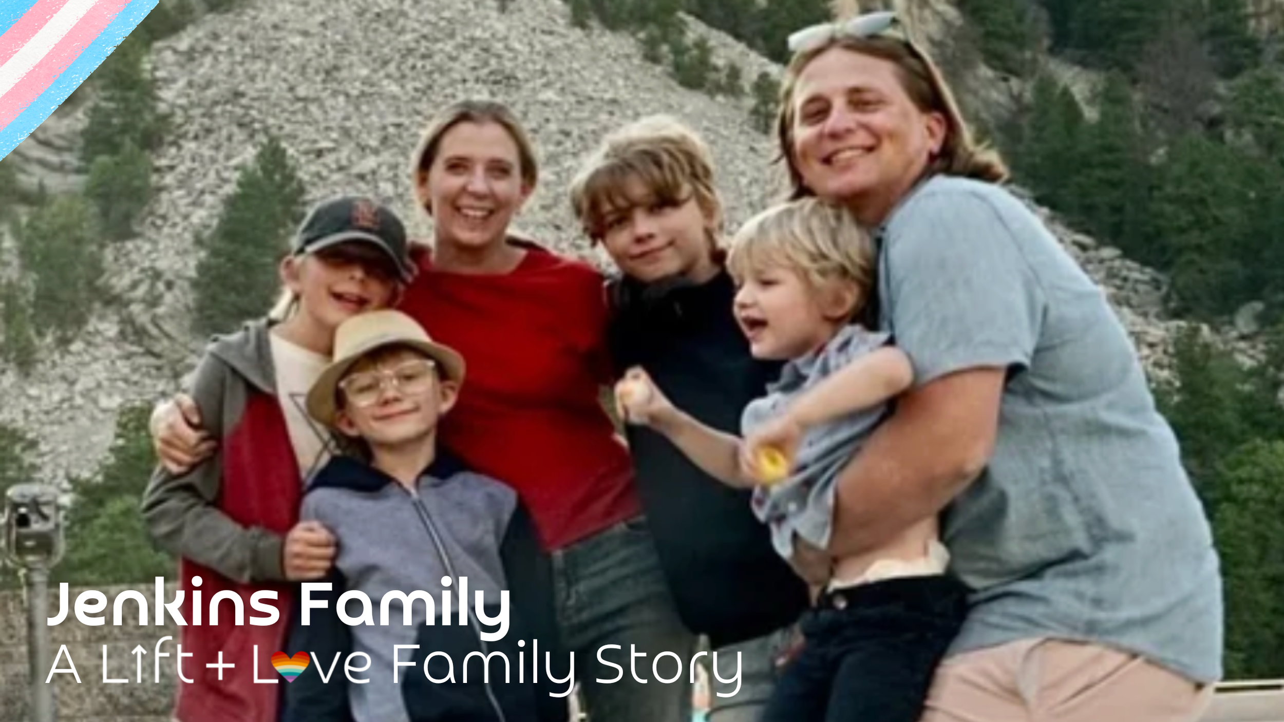 Jenkins family, consisting of four children and two adults, smiling outdoors with a mountain backdrop, celebrating family love.