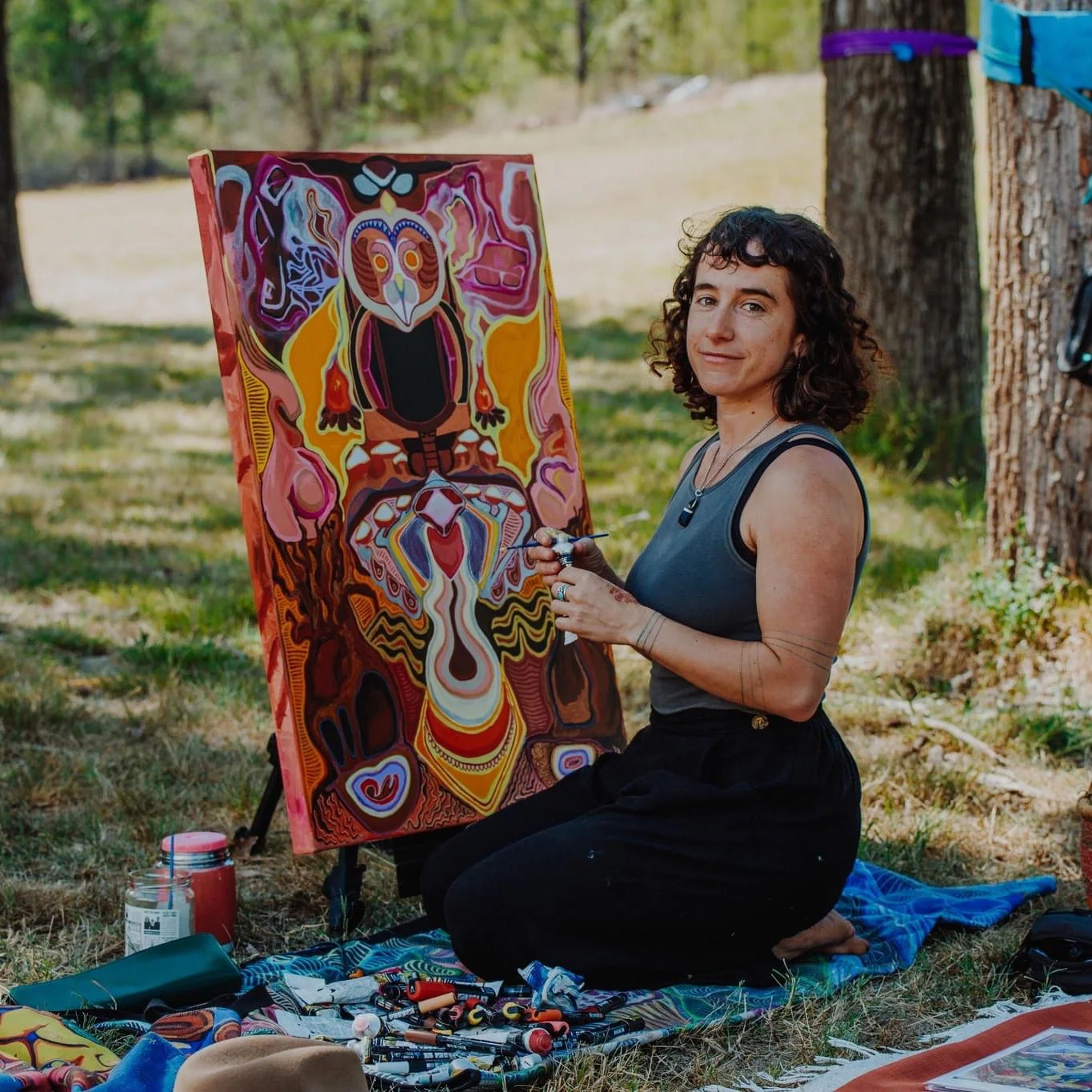 Australian artist Taylor Meagher painting sacred feminine artwork at a women’s gathering