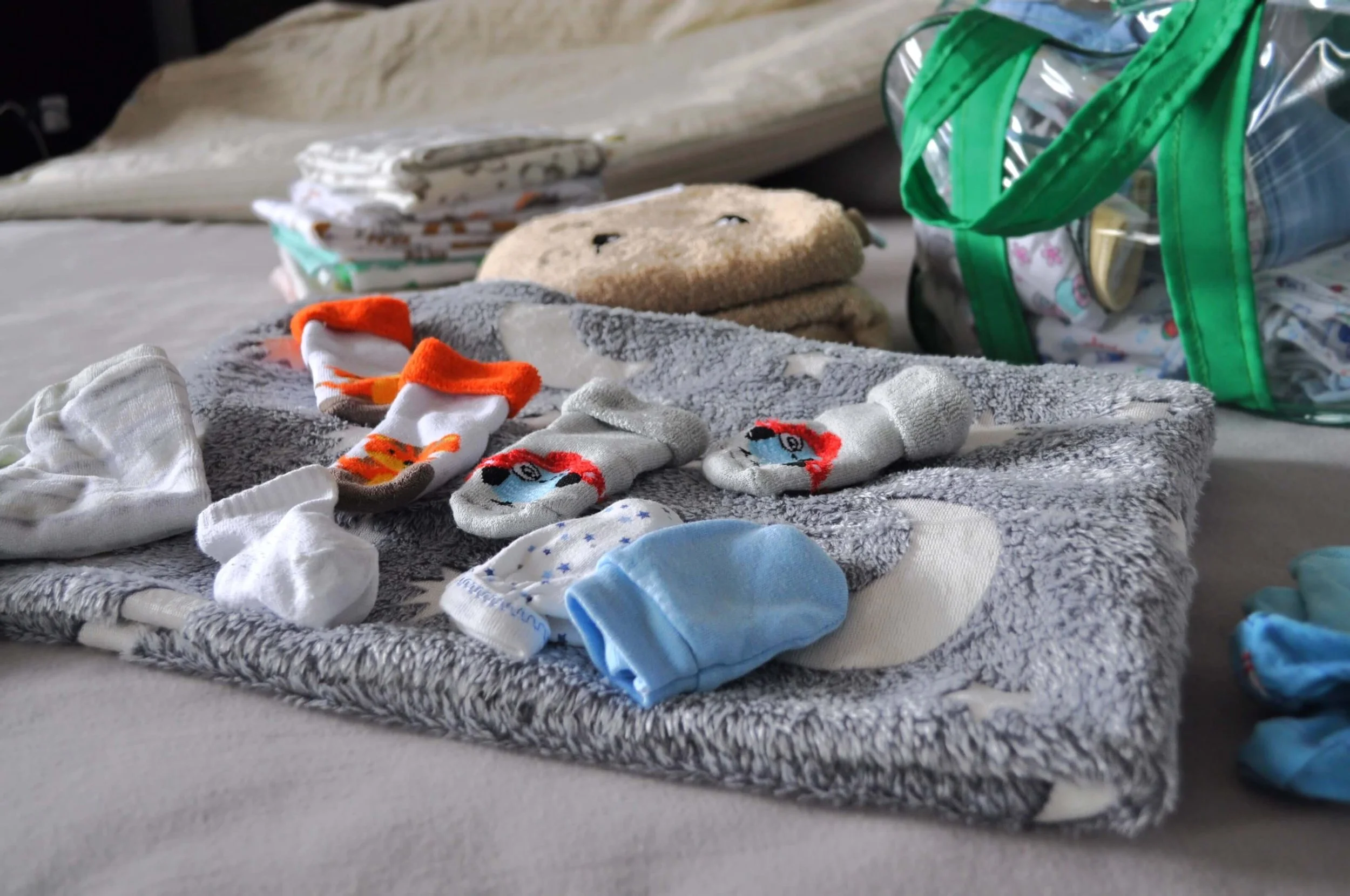 Essential toddler items including diapers, baby powder, lotion, extra socks, a soft brush, and a soft blanket.