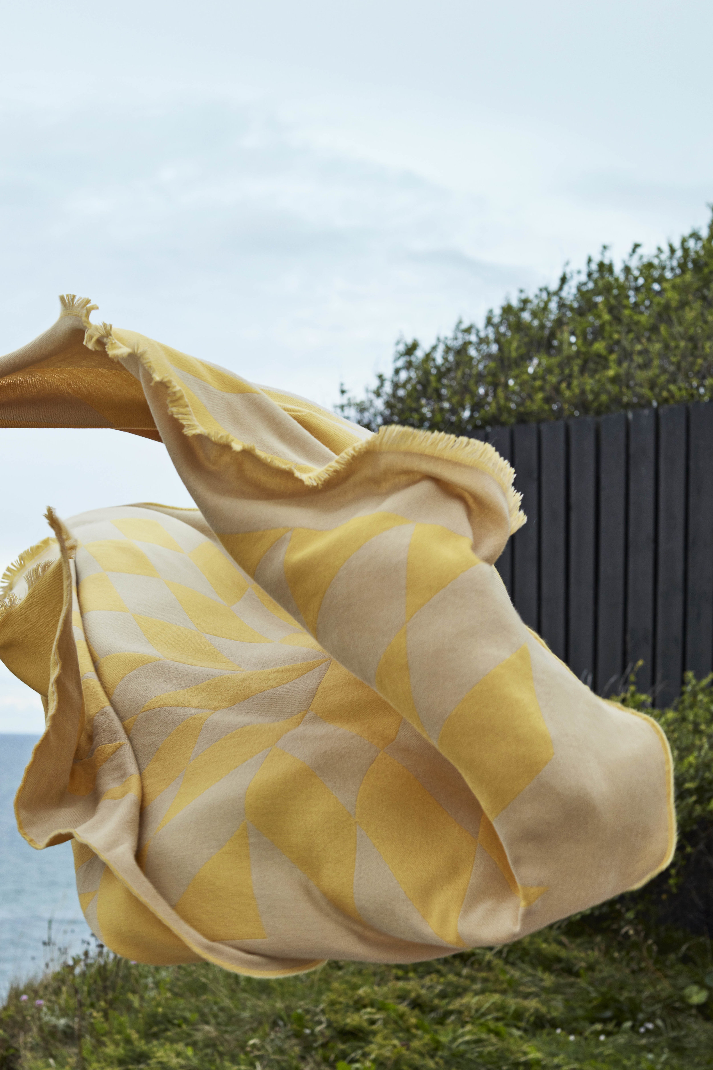 Interior Design Stores in Copenhagen article. Image of yellow blanket from Hay