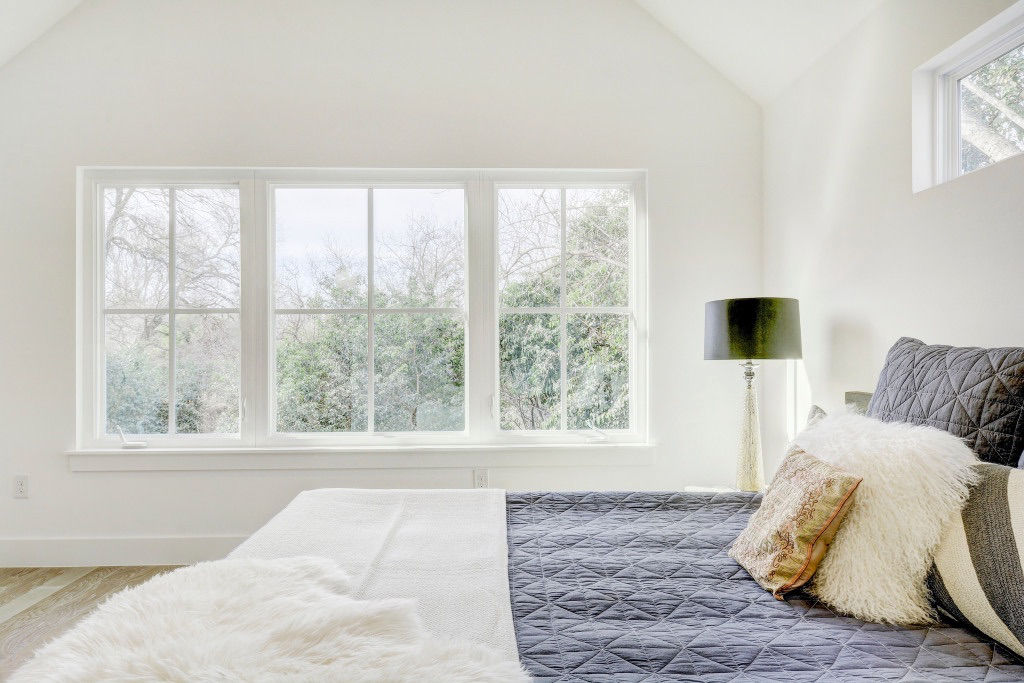 Master bedroom with large, bright windows