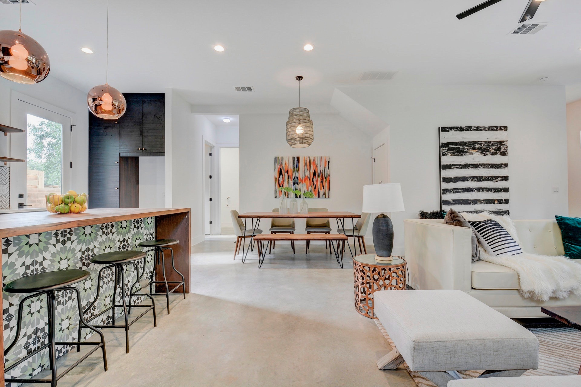 Open living room, dining area, and kitchen island bar