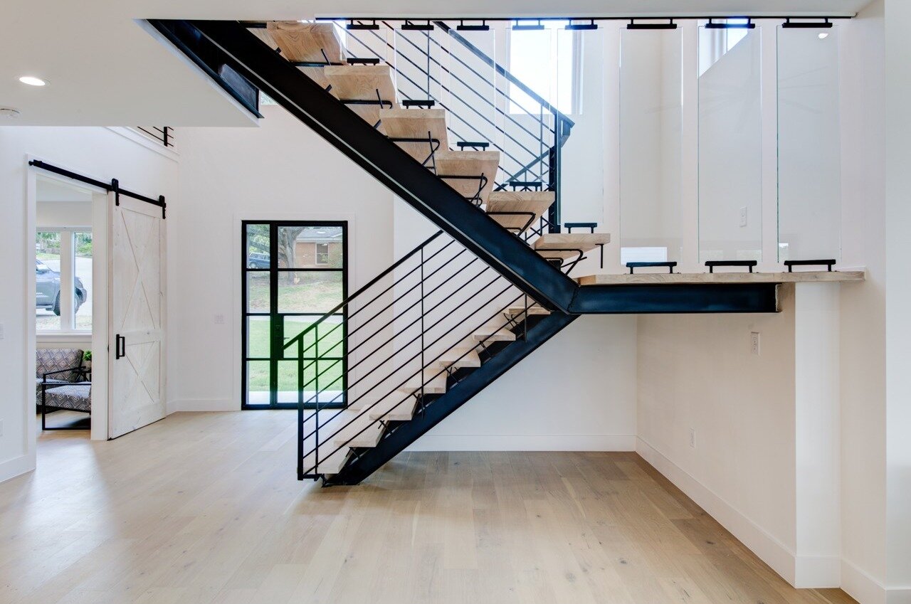 Stunning stairs with glass panels open up the space