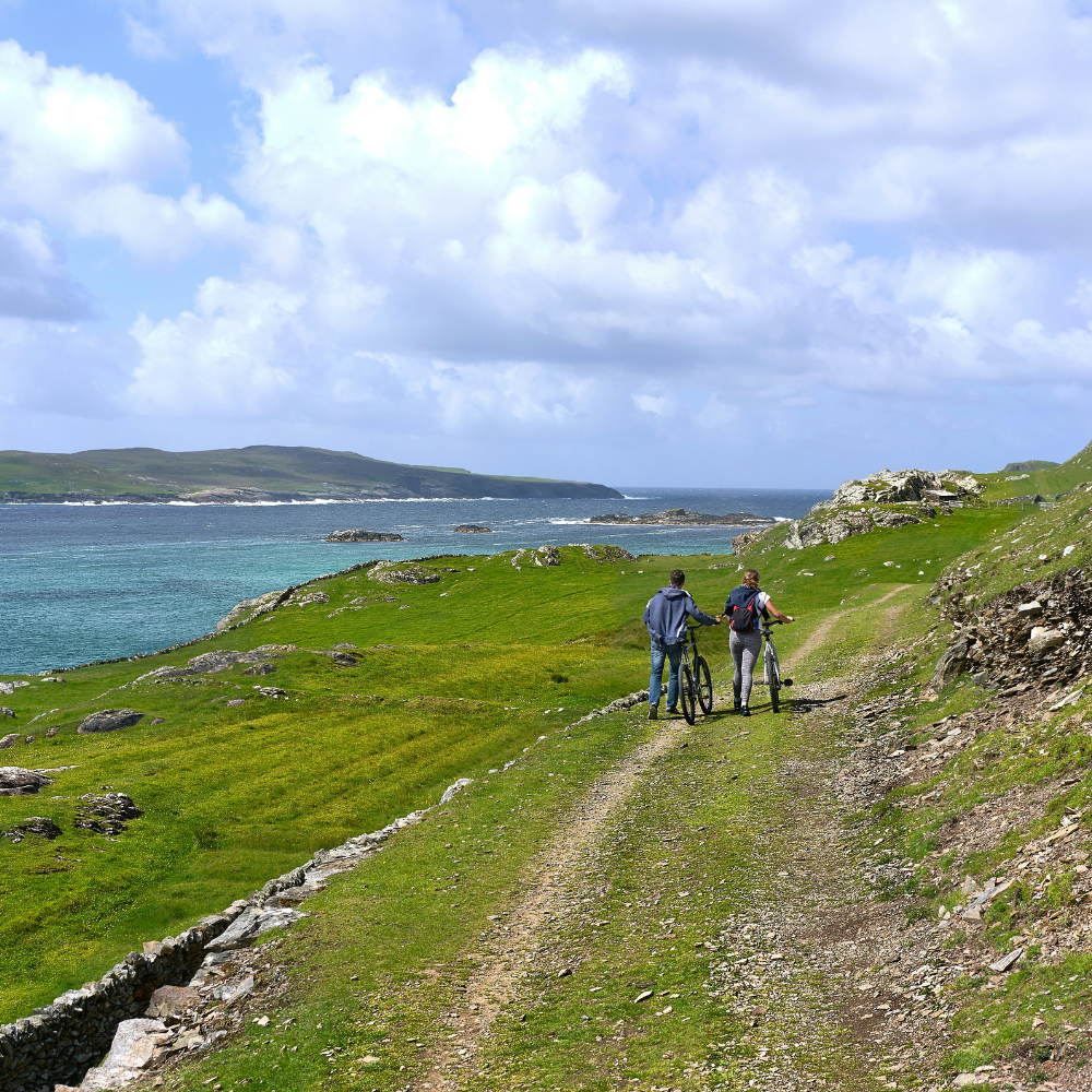 Golden sandy beach on Inishbofin Island with blue ocean, one of the best places to go in Ireland