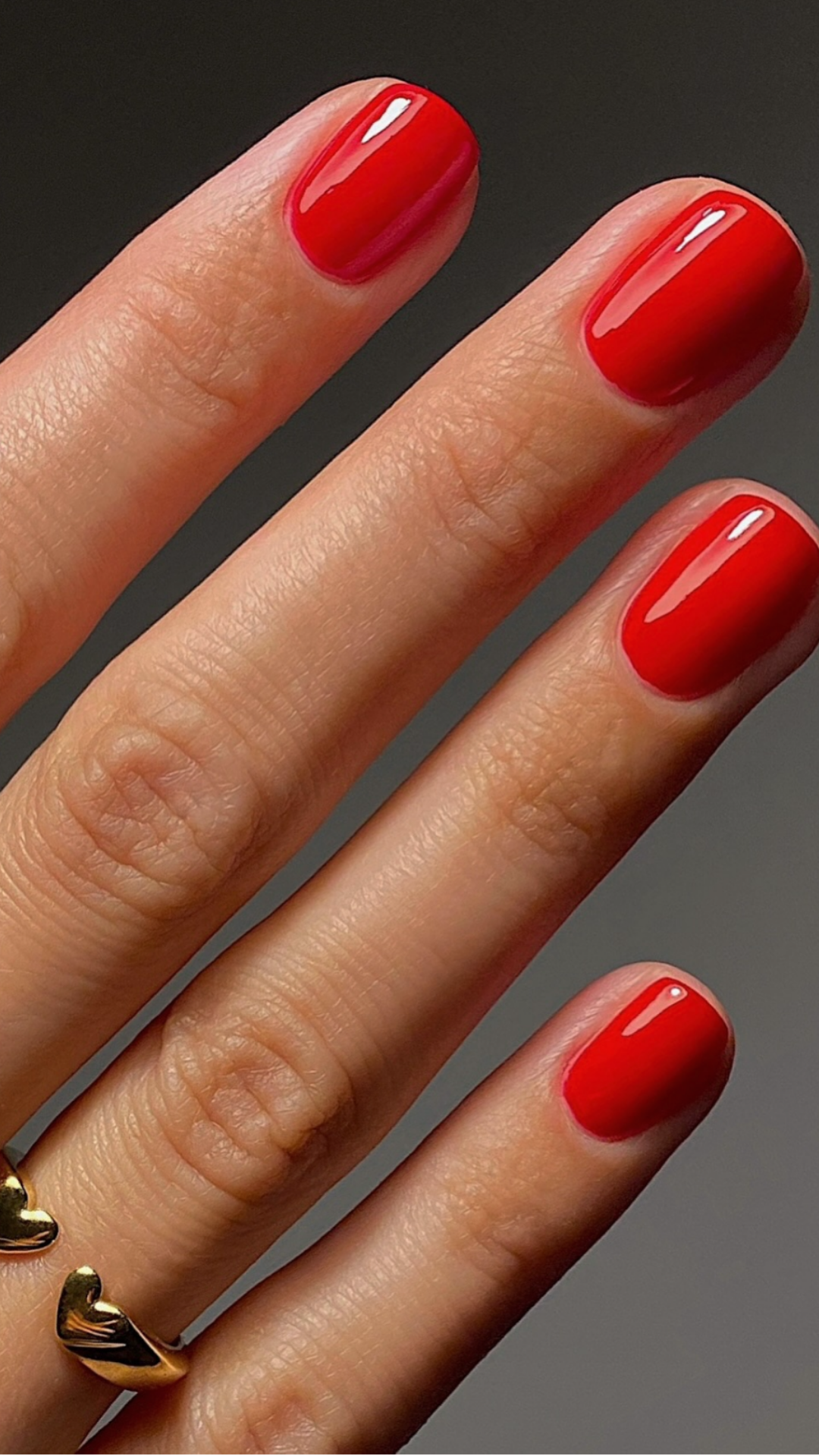 Tomato red spring nails with vibrant warm undertone on short square nails