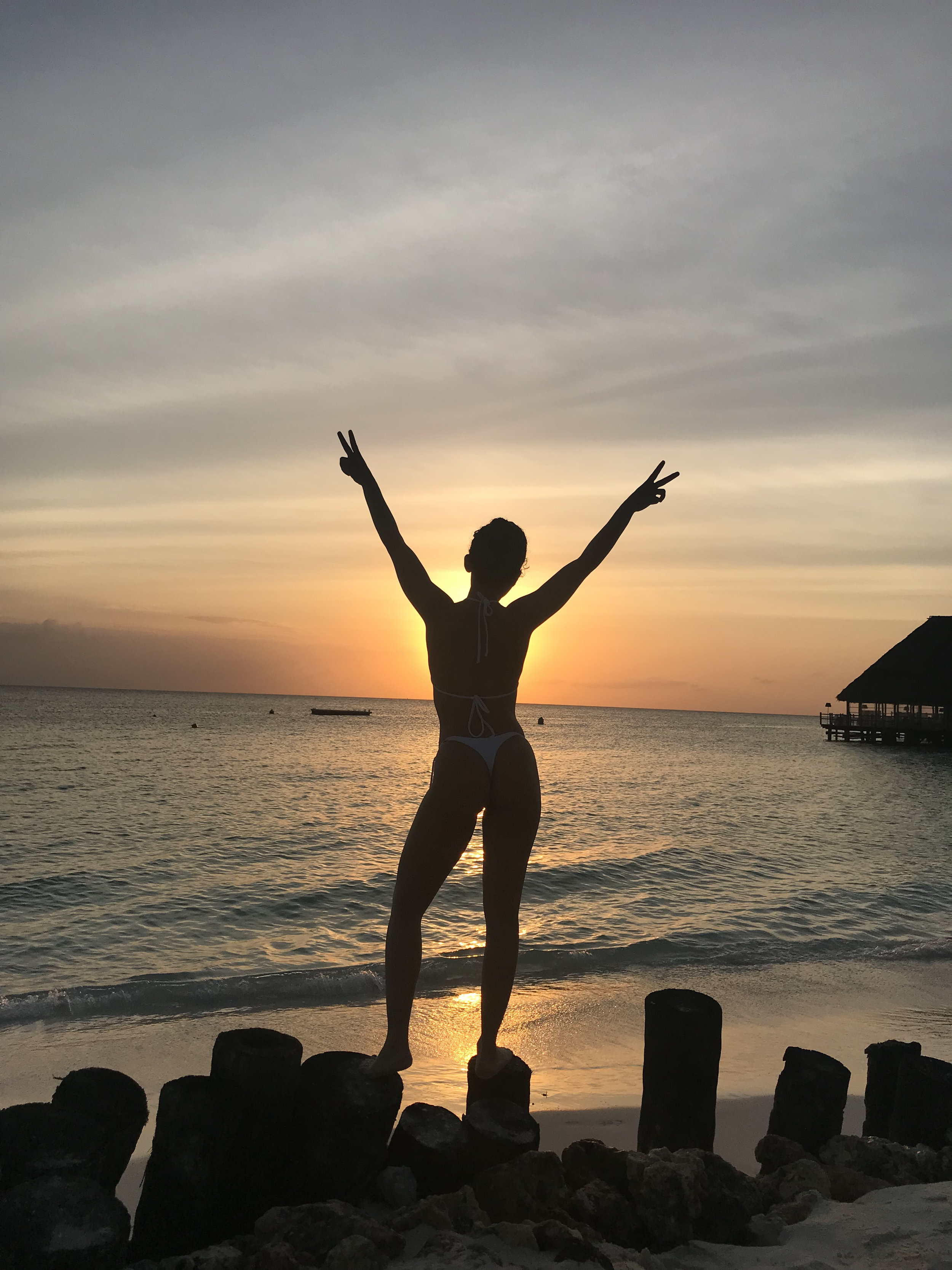 Woman looks  Sunset at Zanzibar Beach