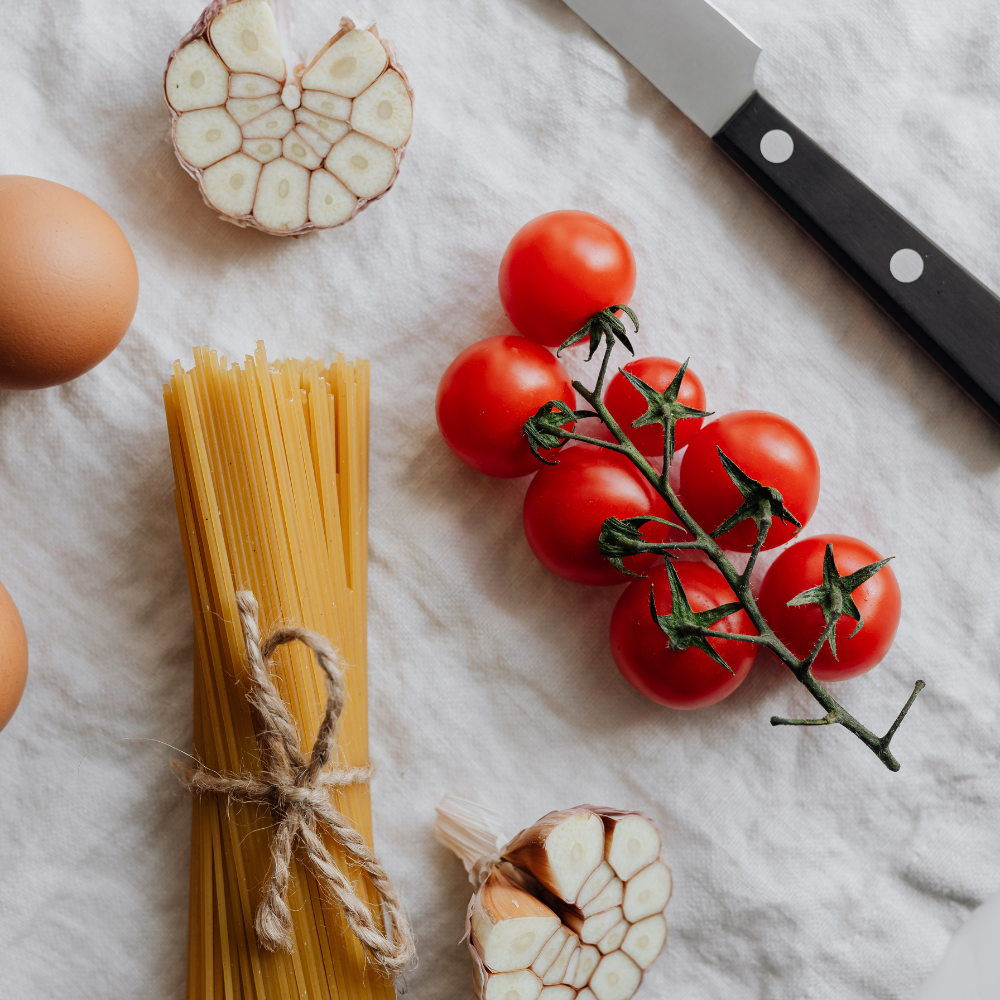 Ingredients for classic pomodoro sauce including San Marzano tomatoes, garlic, olive oil, salt, sugar, and fresh basil.