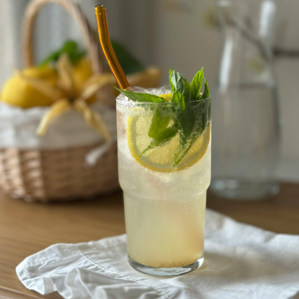 Ginger coconut water drink made with fresh lemon, orange juice, turmeric, and black pepper for a refreshing wellness boost.