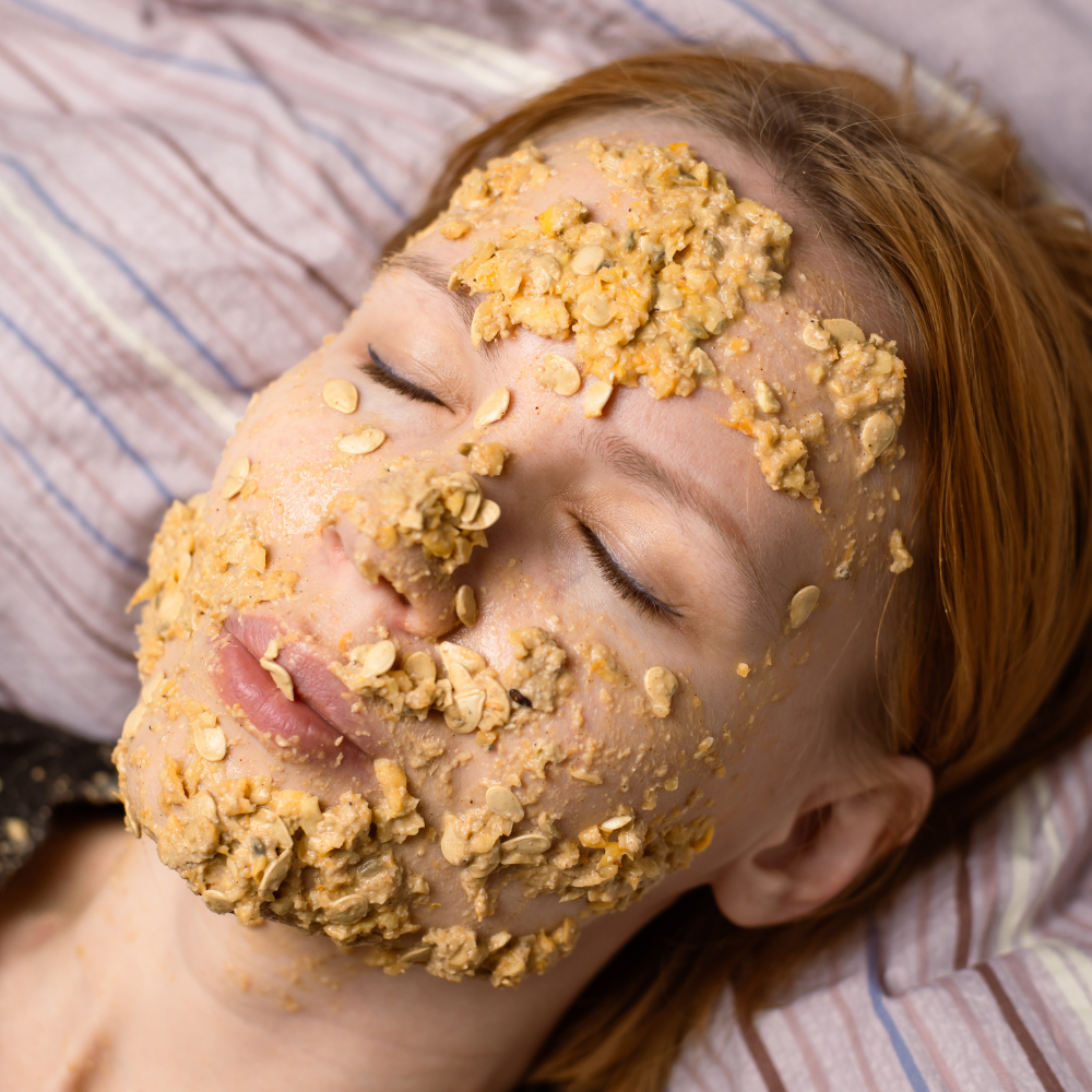 Applying an oatmeal face mask evenly to the face
