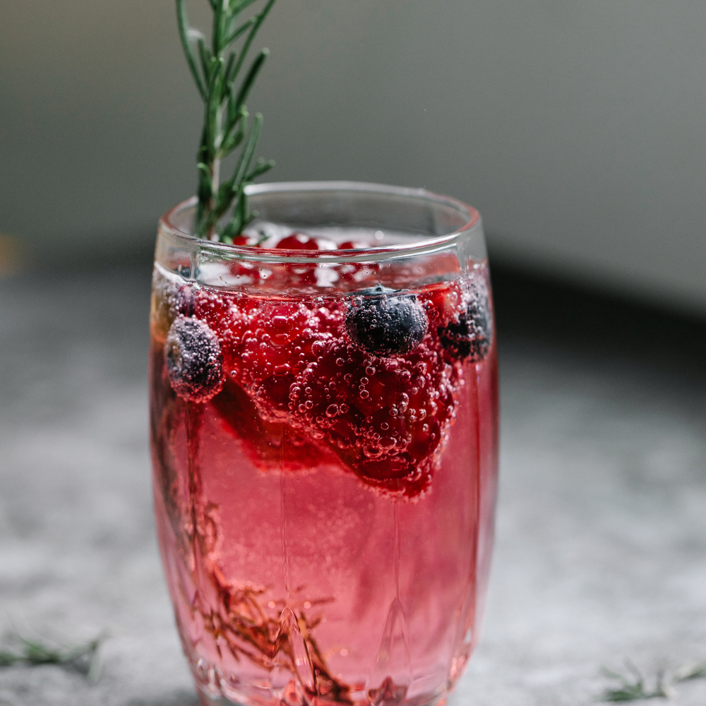 Blackberry rosemary spritz mocktail with sparkling water, fresh blackberries, and rosemary sprigs