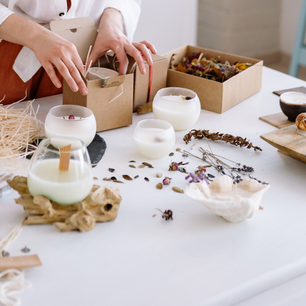 Woman creating DIY Mother’s Day gifts at home using craft supplies, jars, and decorative materials