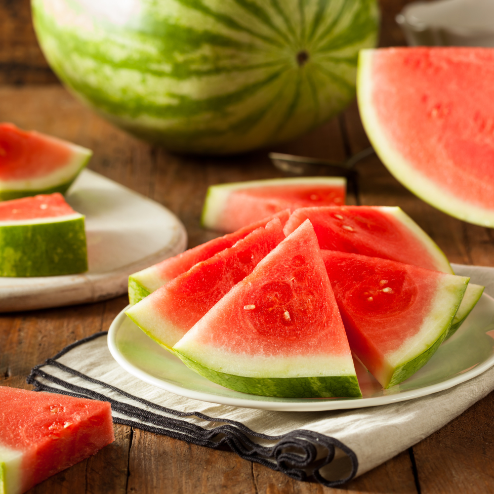 Cutting fresh watermelon into cubes for a watermelon feta salad recipe.