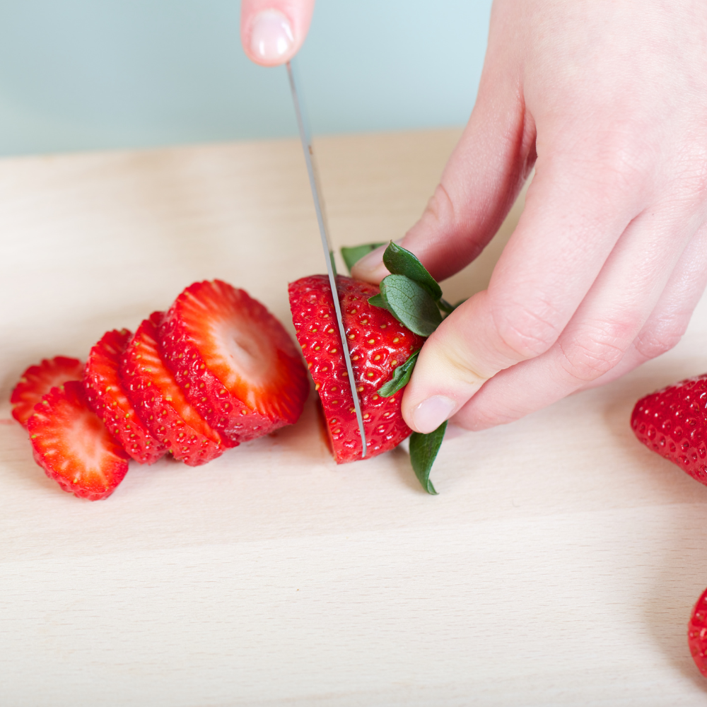 Fresh ripe strawberries sliced for homemade strawberry shortcake filling.