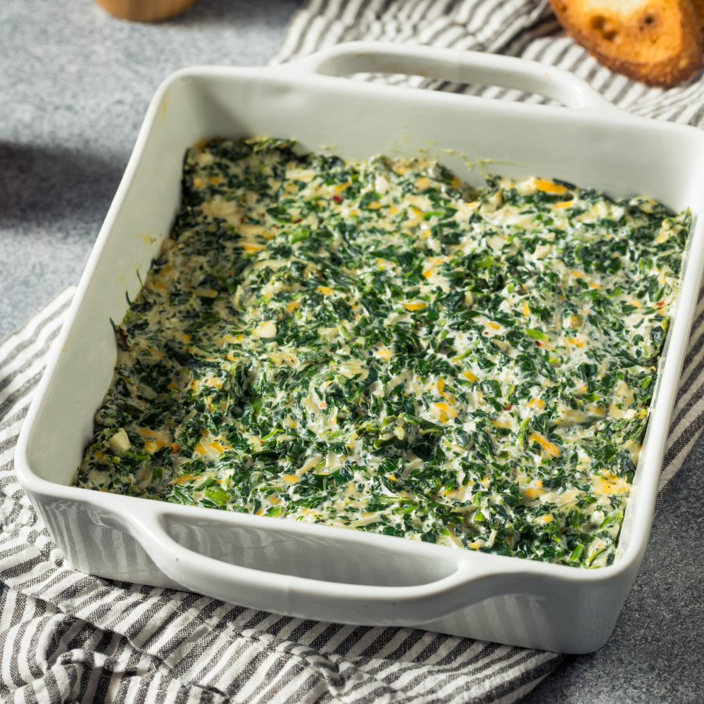 Creamy spinach and artichoke dip served with crackers, one of the best cold dips for parties.