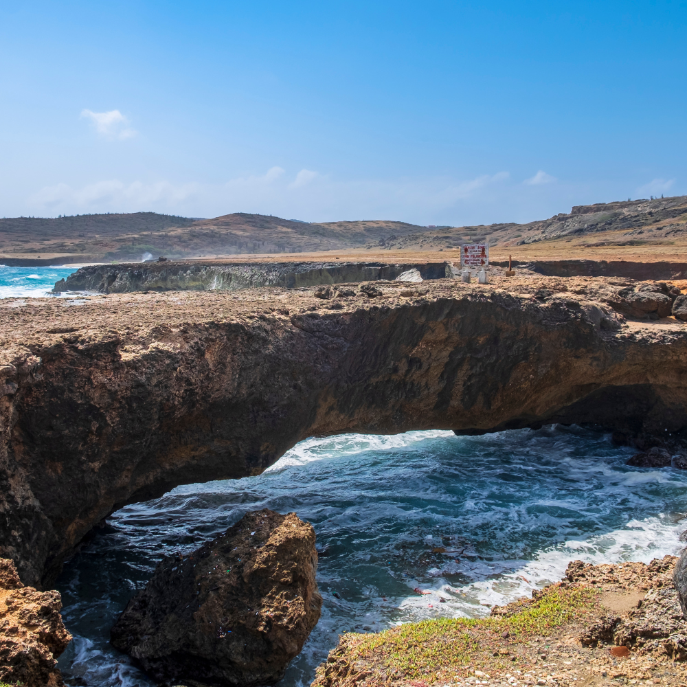 Natural Bridge Aruba showcasing rugged coastline and dramatic ocean views