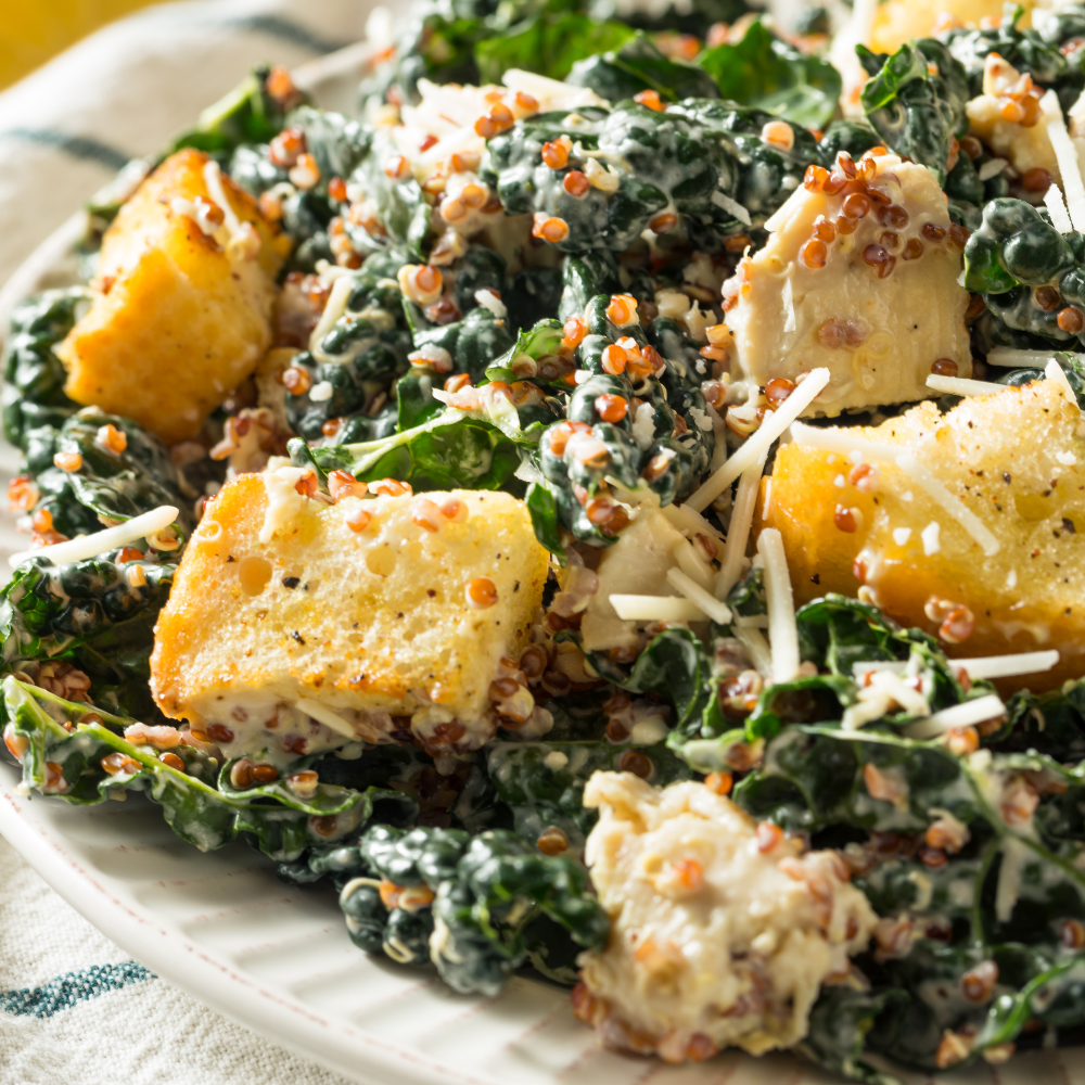 Homemade kale Caesar salad made from scratch with kale, romaine, Parmesan, creamy dressing, and golden croutons