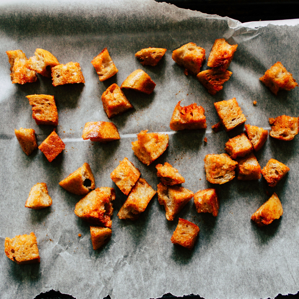 Golden homemade kale Caesar salad croutons baked until crispy