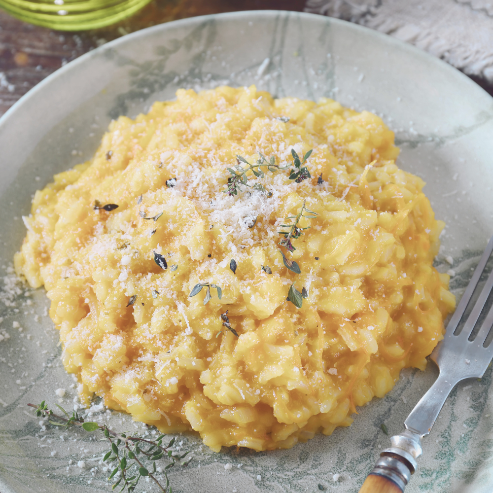 Close up of saffron infused risotto with golden color and creamy texture