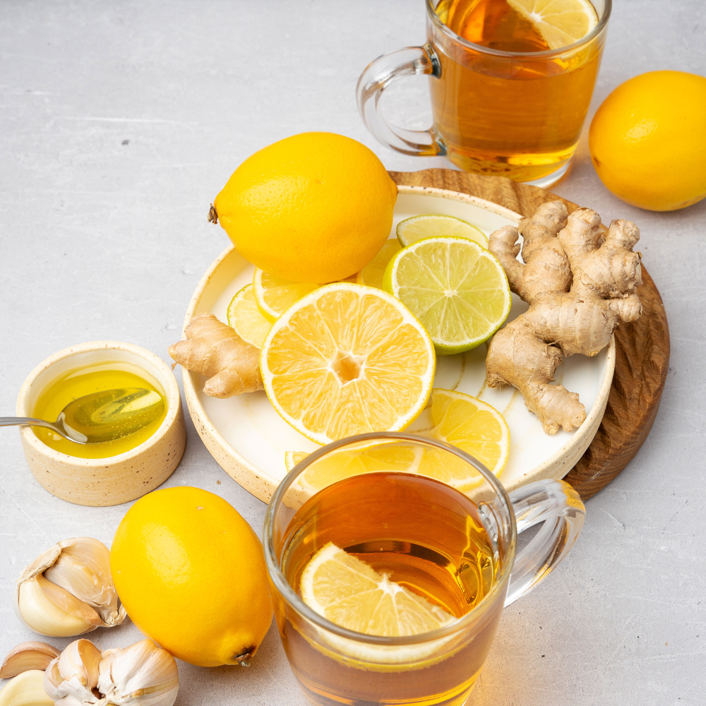 Steaming cup of fresh ginger tea made from fresh ginger root, lemon, and honey
