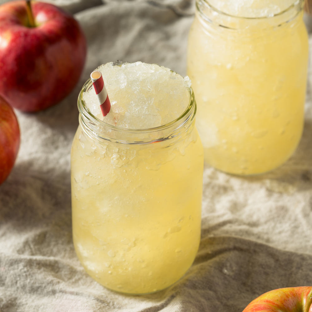 Sparkling apple spritz mocktail with fresh ginger juice, lime, and ice cubes
