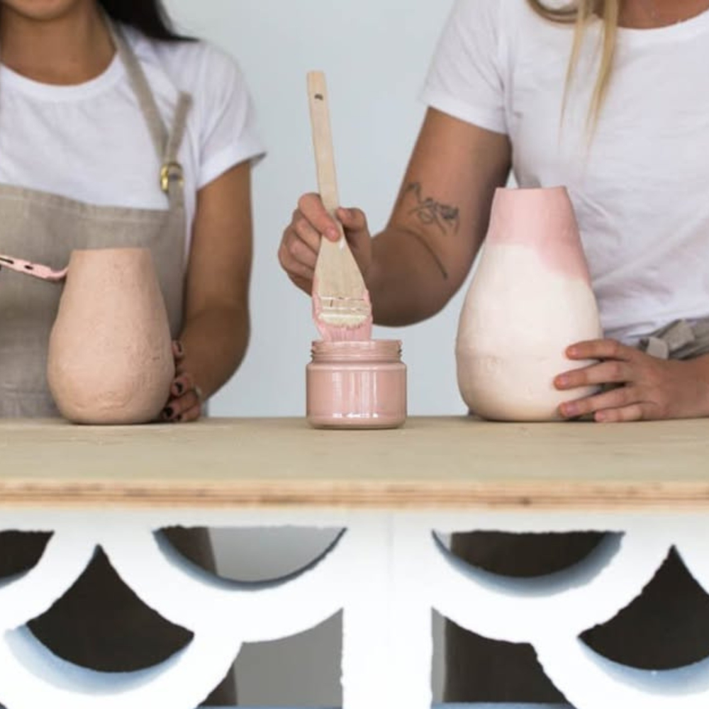 Friends taking a DIY craft class together and learning a new creative skill.