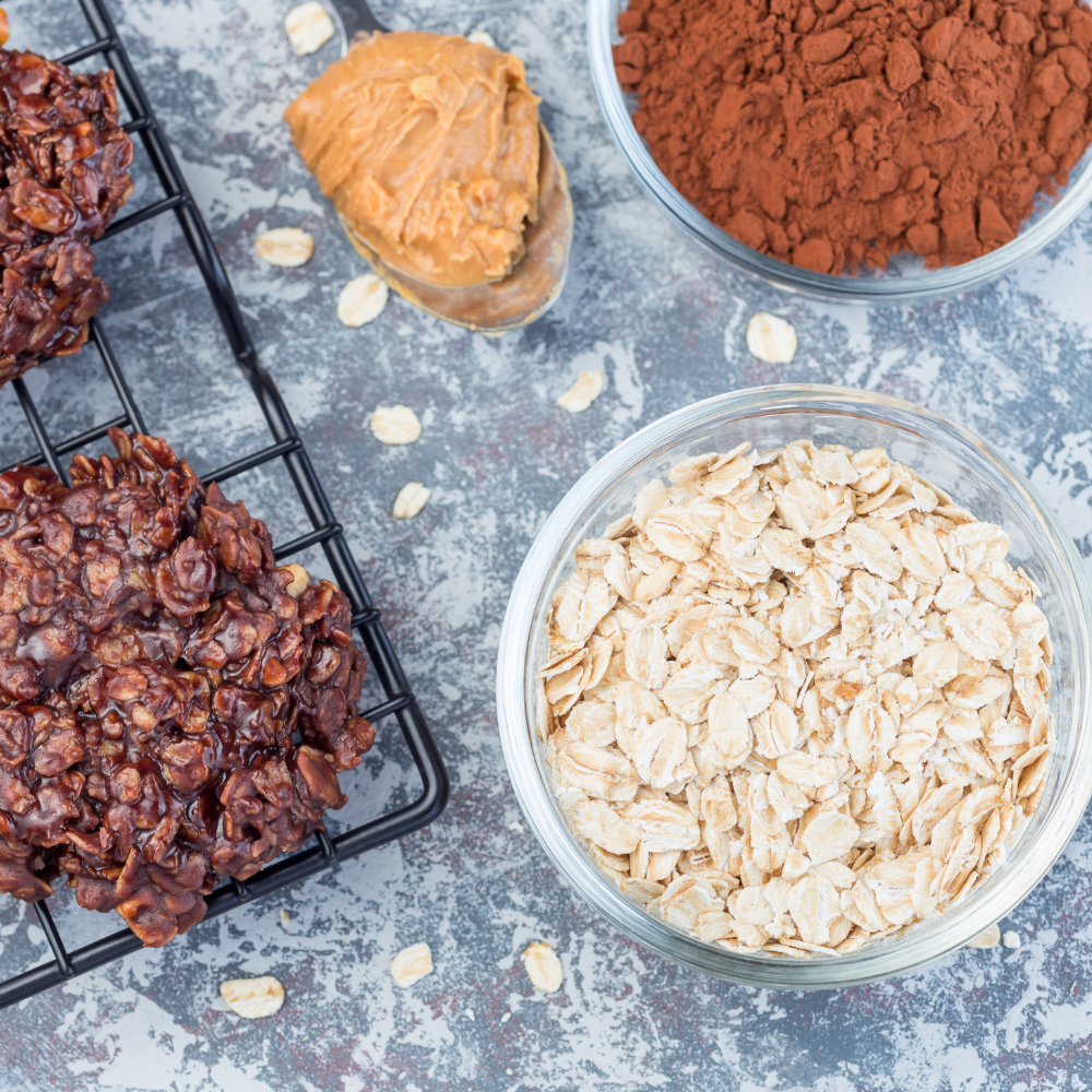 Ingredients for chocolate peanut butter no-bake cookies including peanut butter, oats, cocoa powder, honey, and coconut oil.