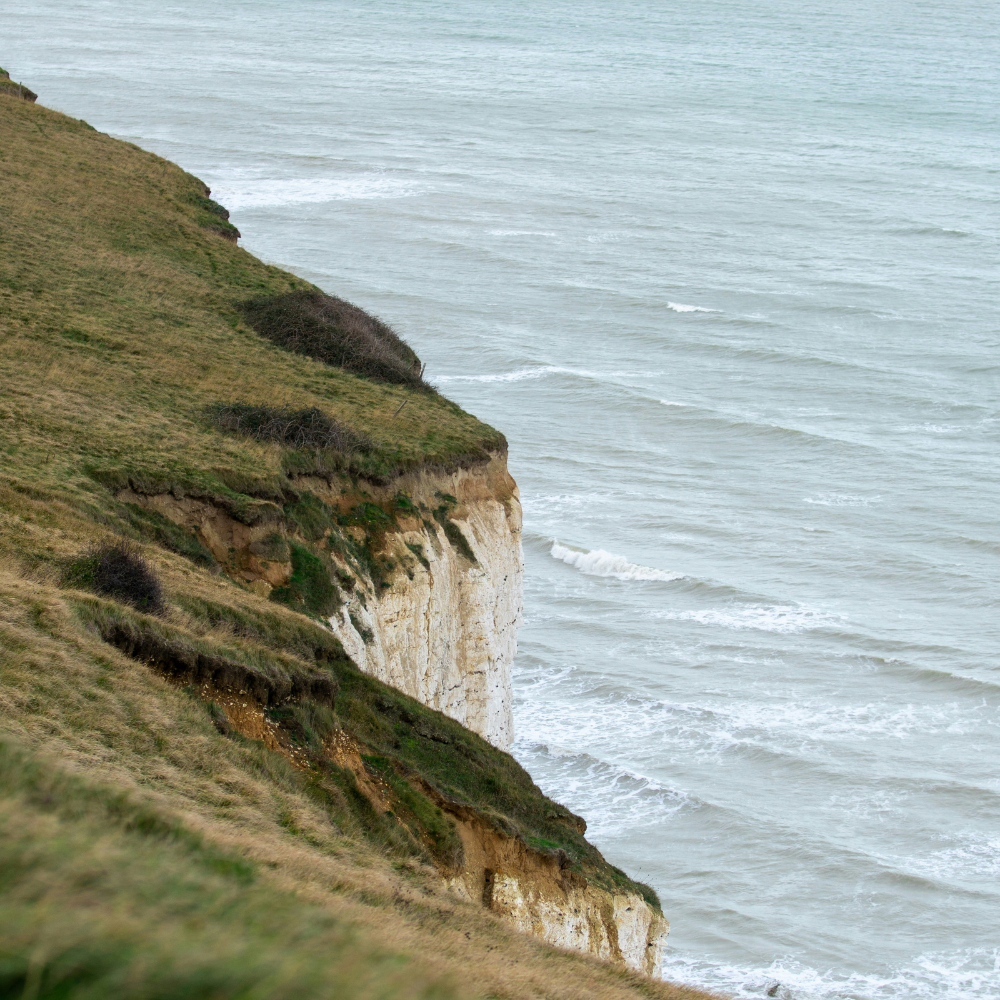 Dramatic white cliffs and sea arches of Étretat in Normandy along one of the best road trips in Europe.