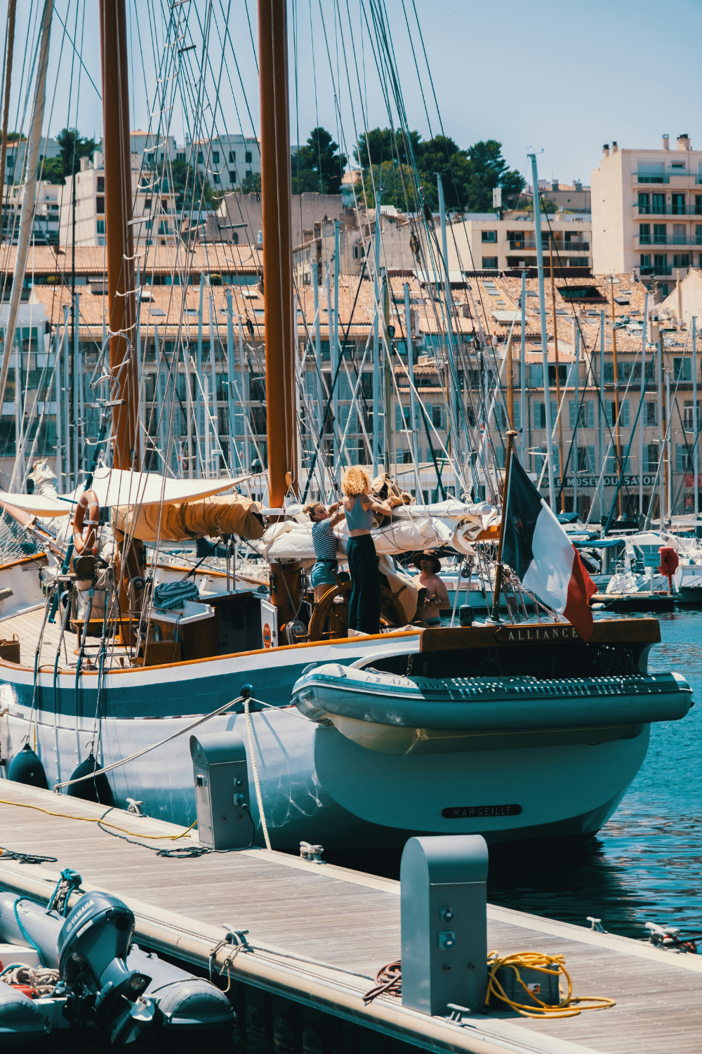 Boats docked at Vieux-Port harbor in Marseille, France with cafés and waterfront views