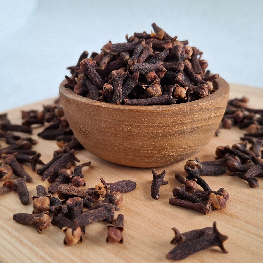 Whole cloves and a cup of water