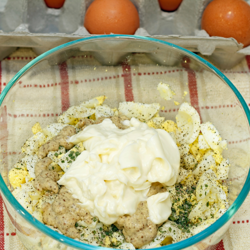 Egg yolks mixed with mayonnaise and Dijon mustard to create a creamy base for egg salad.