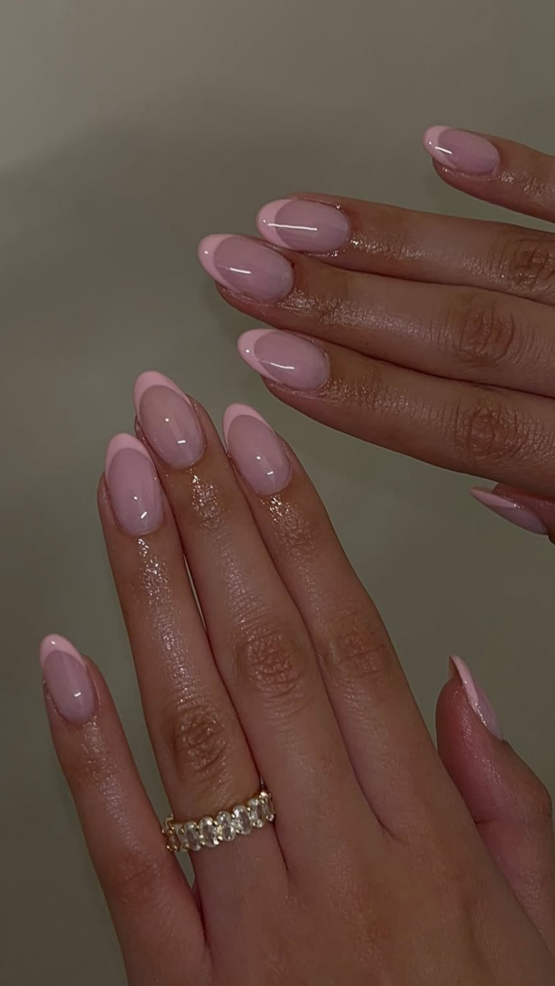 Pearl pink spring nails with soft shimmer and glossy almond shape