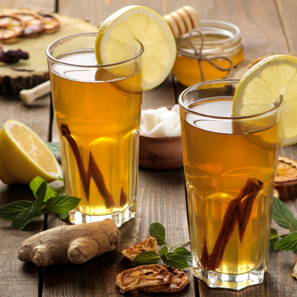 Refreshing iced fresh ginger tea with fresh mint leaves and lemon, perfect for summer