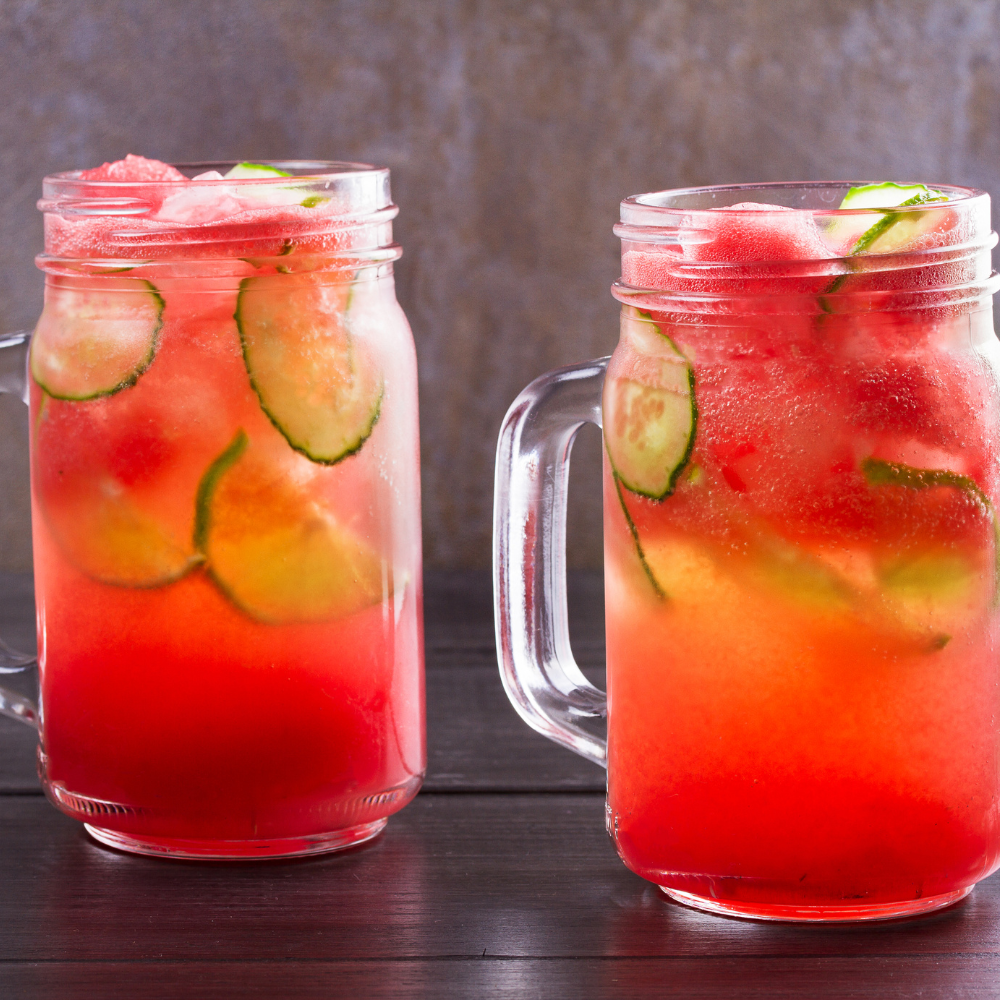 Fresh watermelon cucumber juice poured over ice for a refreshing summer drink.