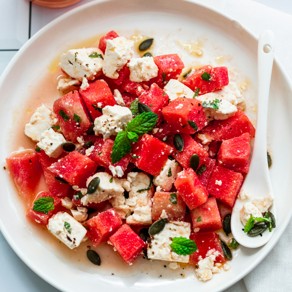 Healthy watermelon feta salad served as a light summer side dish with fresh herbs and nuts.
