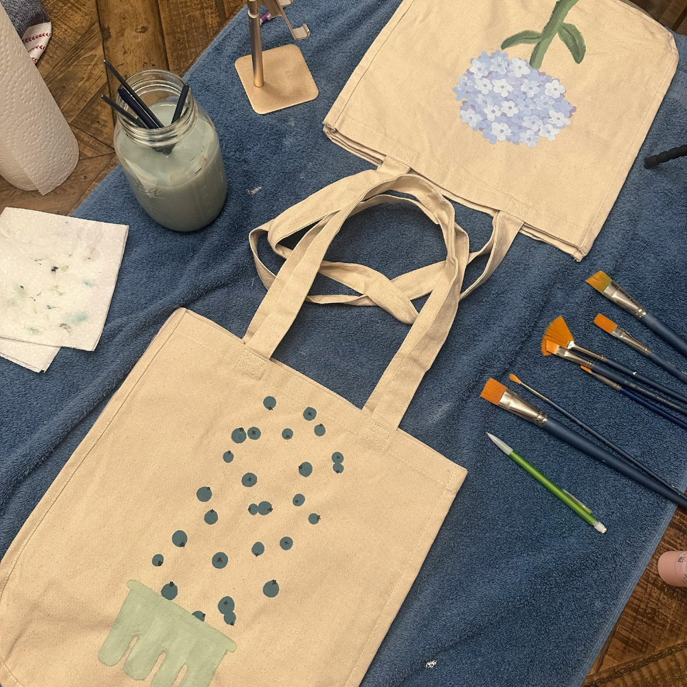 Custom DIY tote bag with fabric paint and iron-on vinyl design as a practical Mother’s Day gift