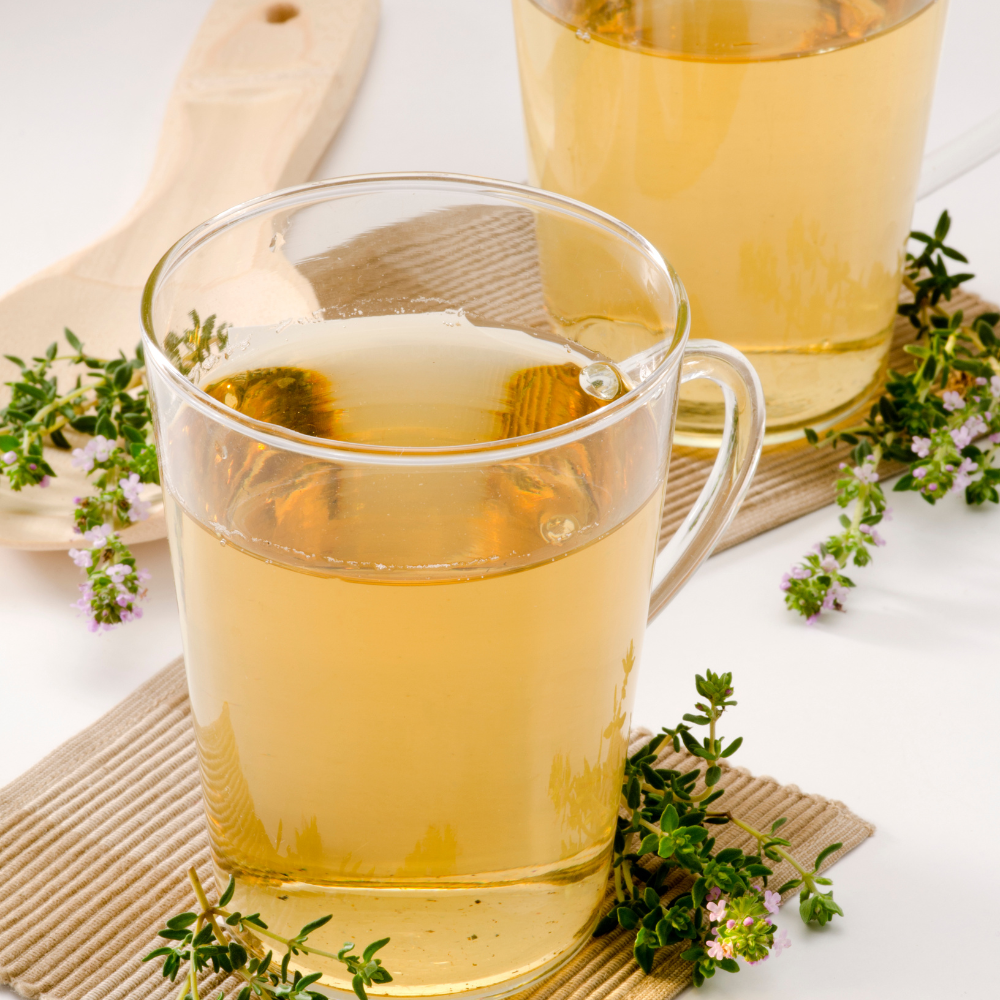 White iced tea with thyme, lemon juice, and ice.