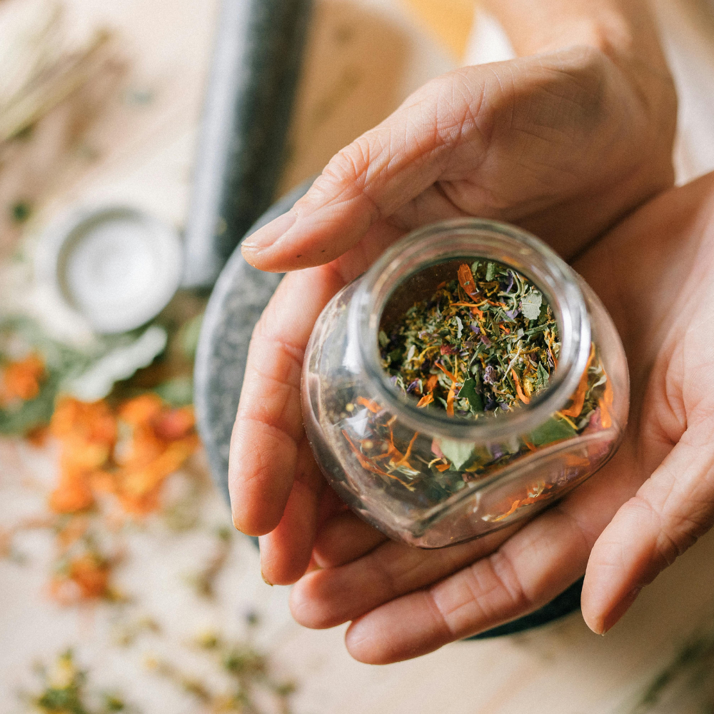 Storing loose leaf tea in an airtight glass container for freshness.