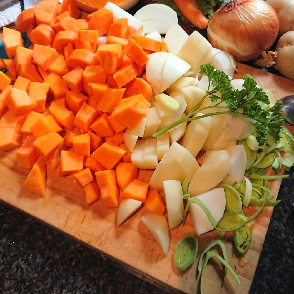 Ingredients for carrot ginger soup including carrots, ginger, onion and garlic.