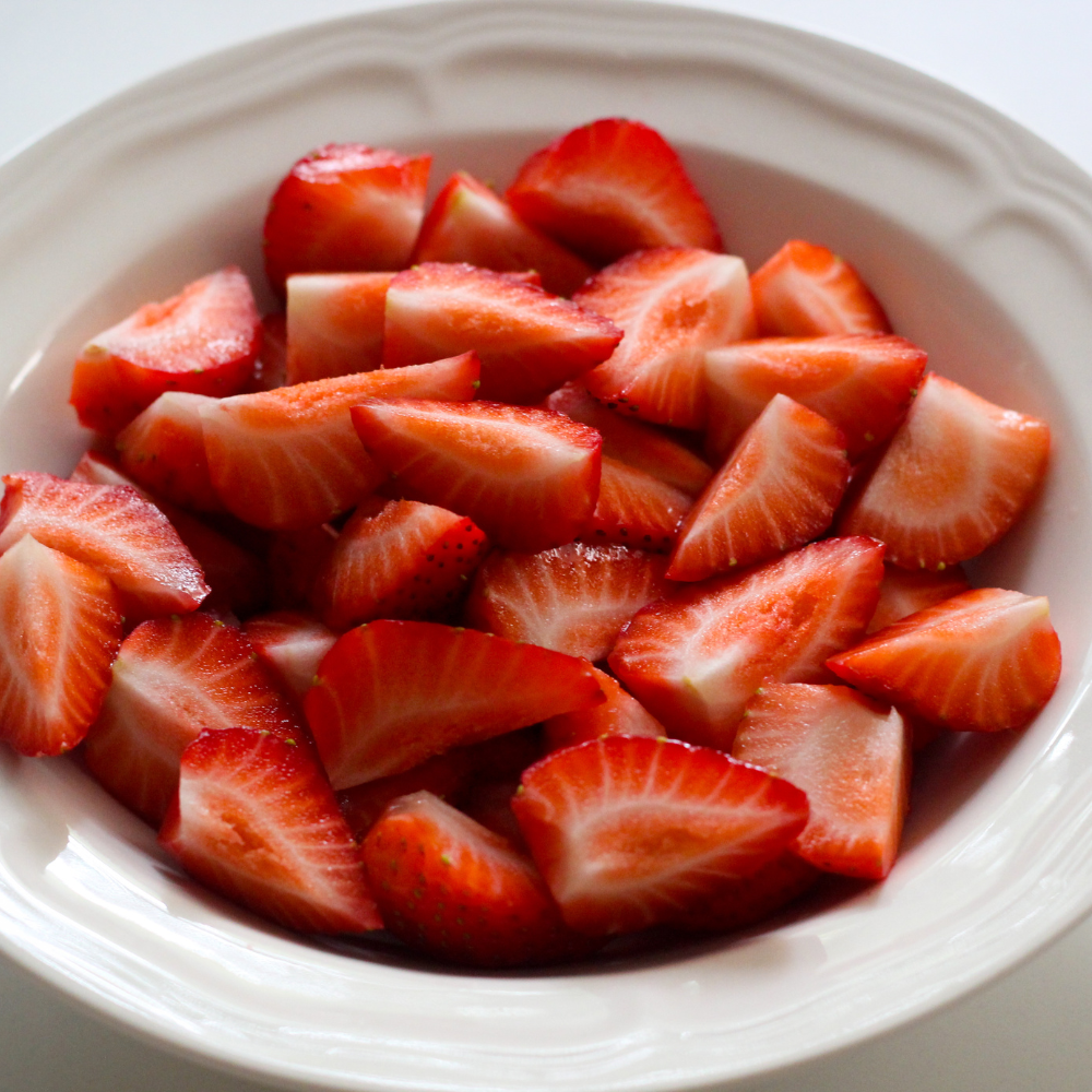 Macerated strawberries with sugar creating syrup for strawberry shortcake.