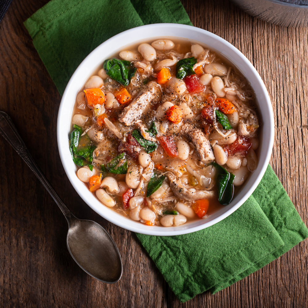 Serving ham and bean soup from a large pot for a cozy family meal.