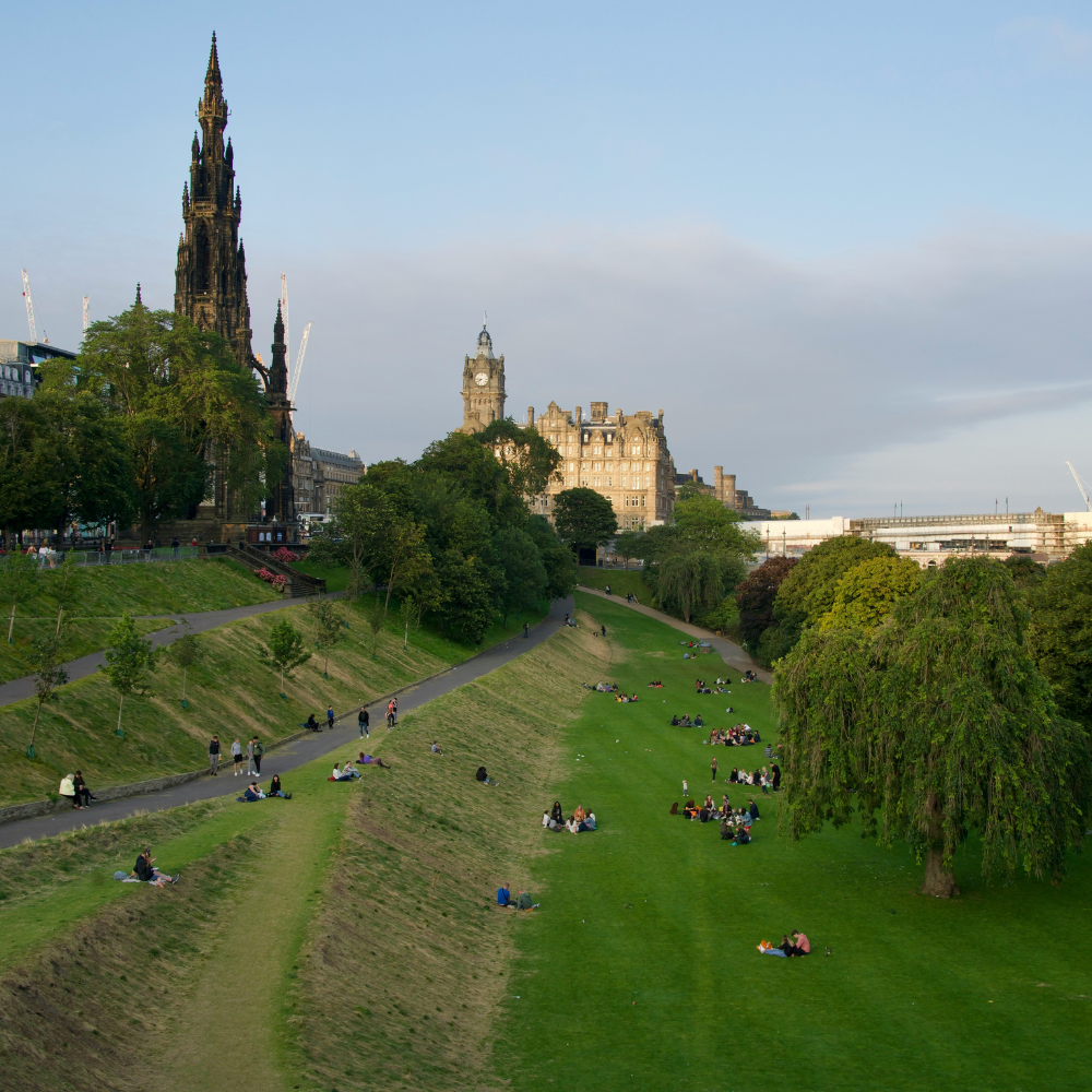Lush Princes Street Gardens with Edinburgh Castle visible in the background.