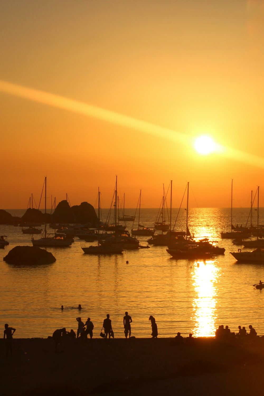 Sunset over Île Calseraigne near Marseille, France, with golden light reflecting on the Mediterranean Sea and rocky coastal landscape