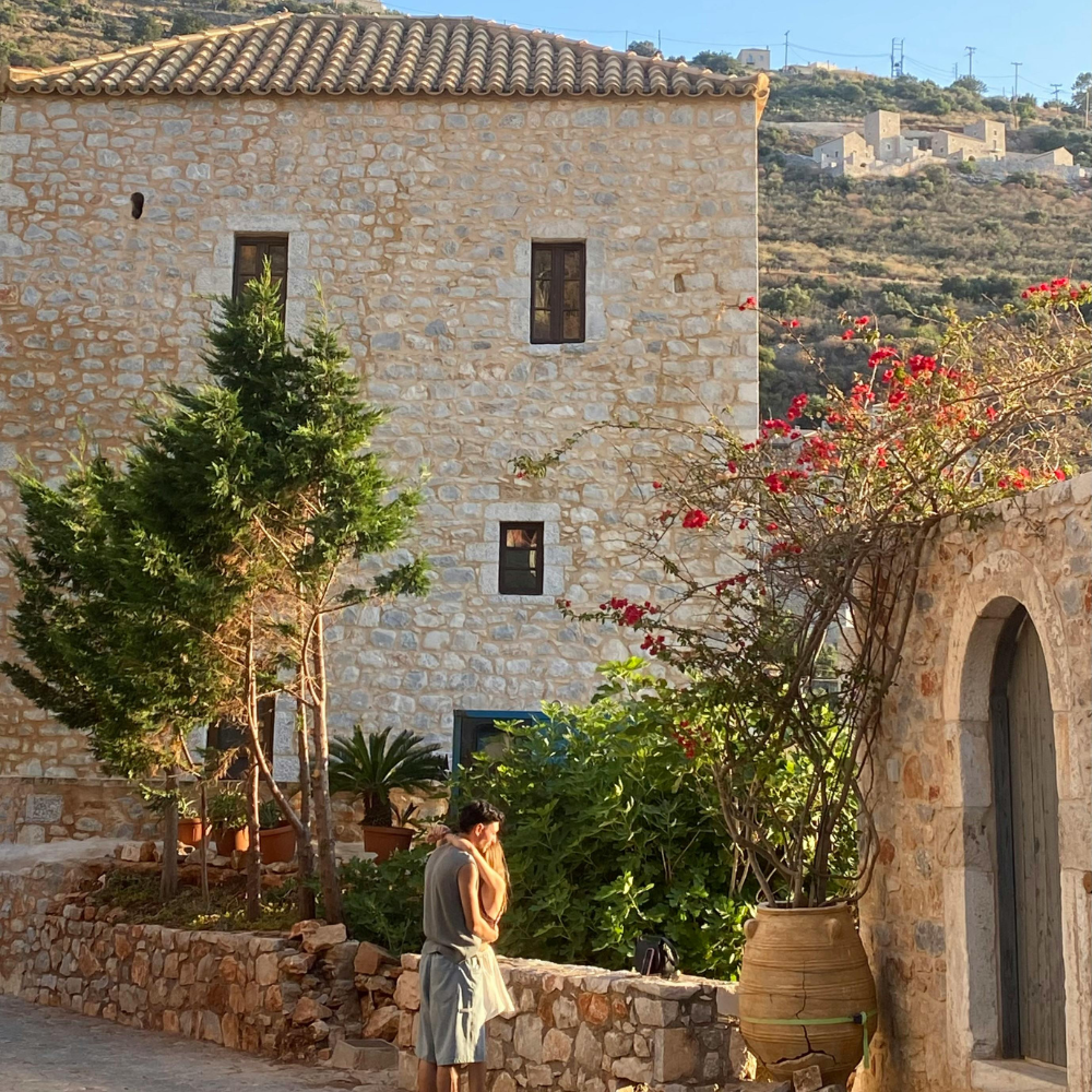 Couple near Ancient Lion Gate ruins in Mycenae during a Peloponnese road trip.